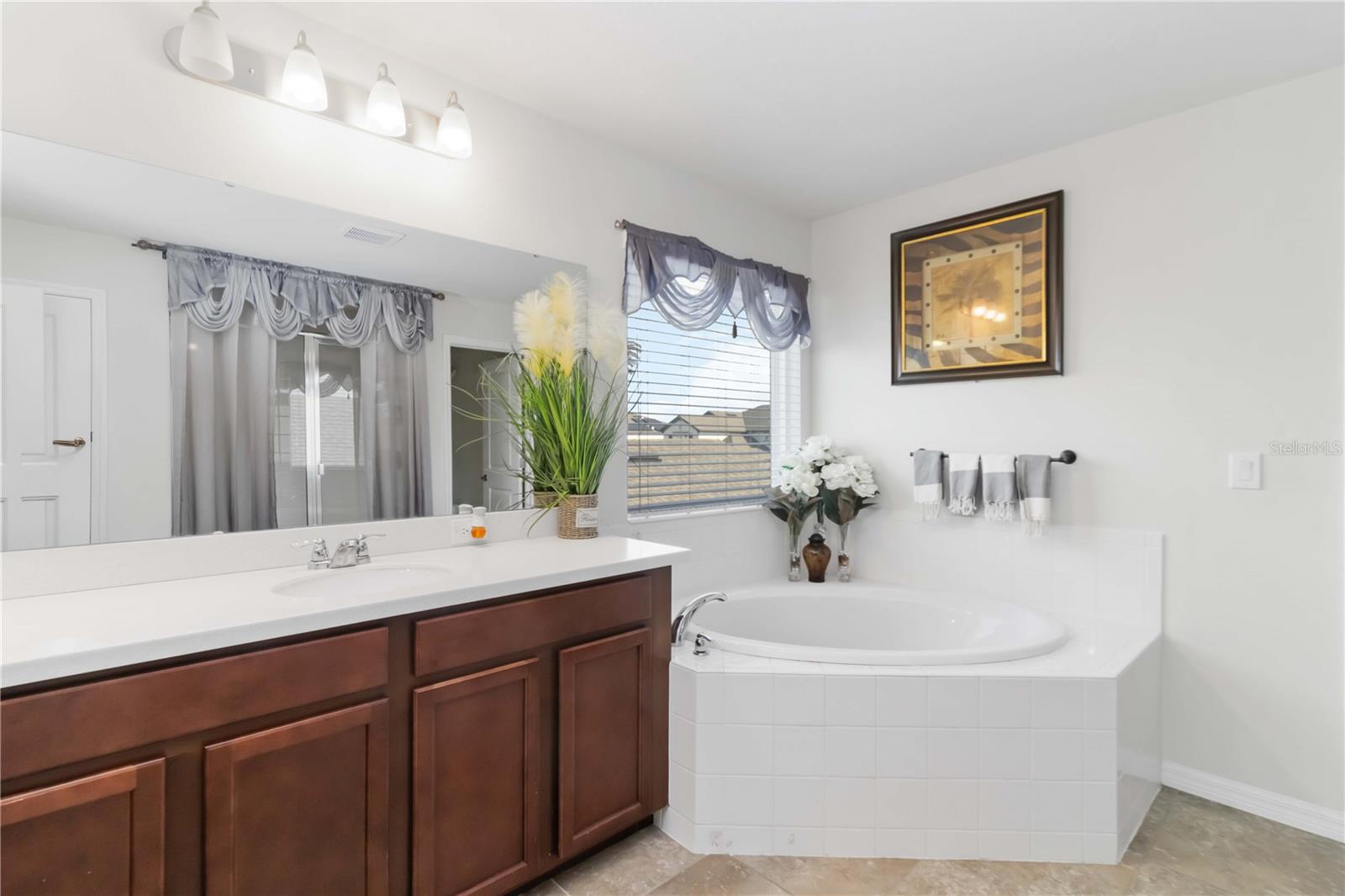 Owner's bathroom with double sink, tub and shower