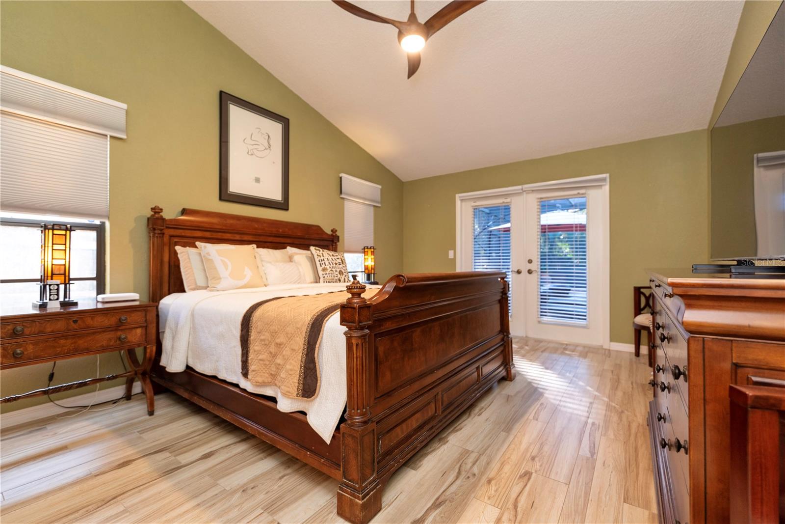 Primary bedroom with French doors to the pool lanai.