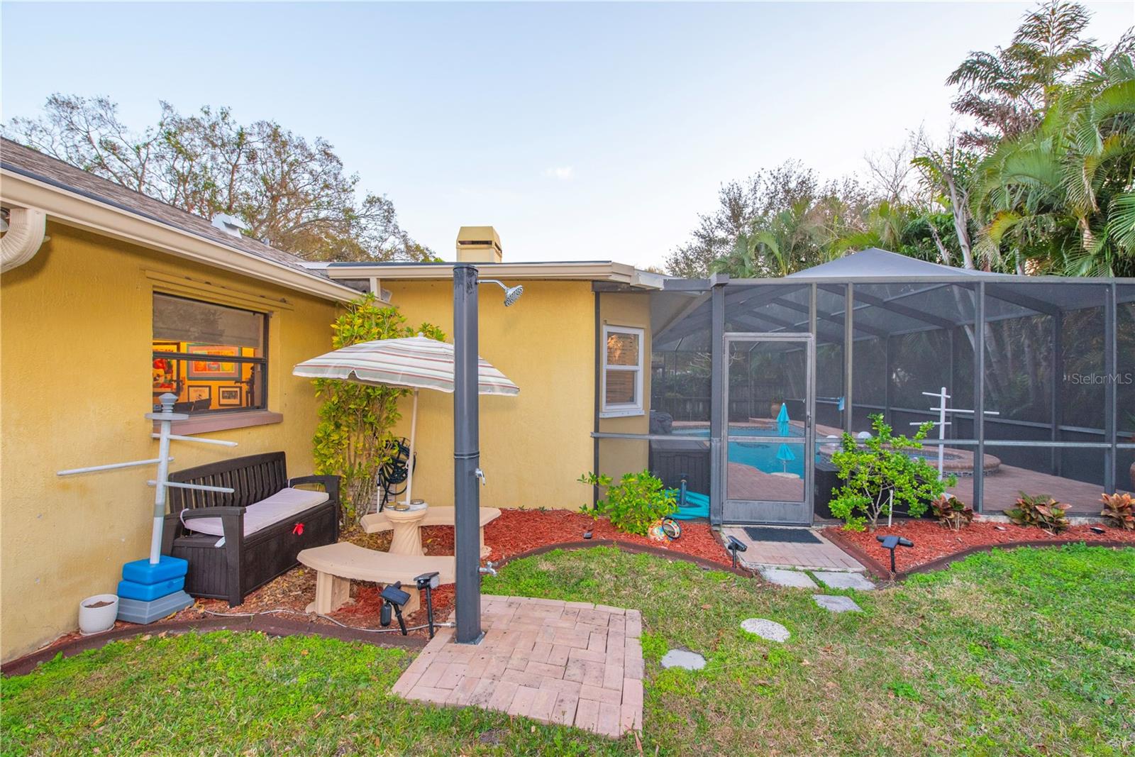 Sitting area in the back yard with outdoor shower.