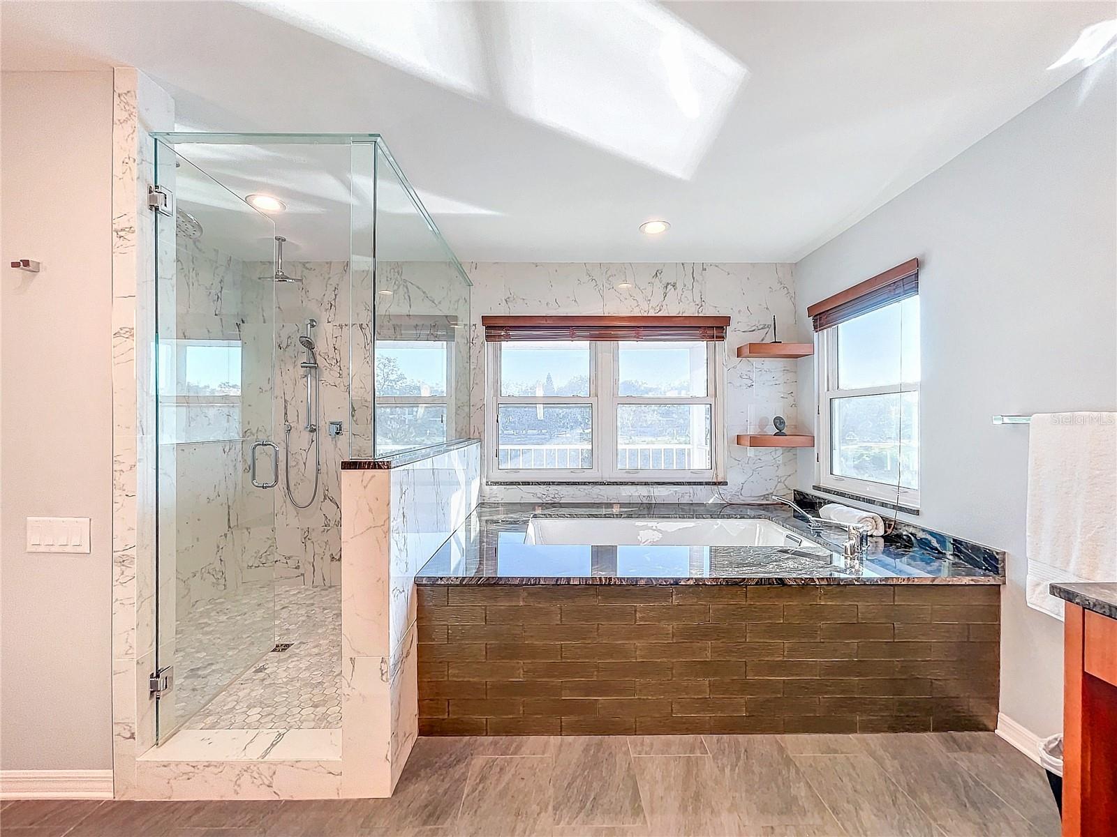 Owner suite shower and tub with river views!