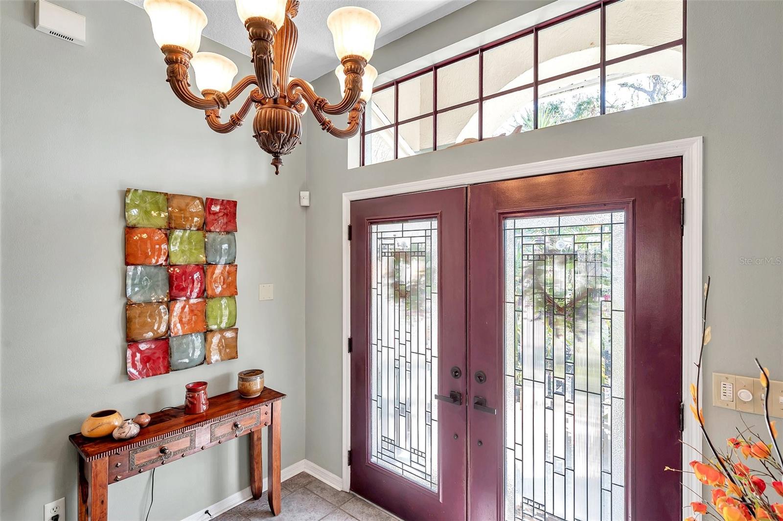 The decorative glass double doors and transom window provide abundant natural light