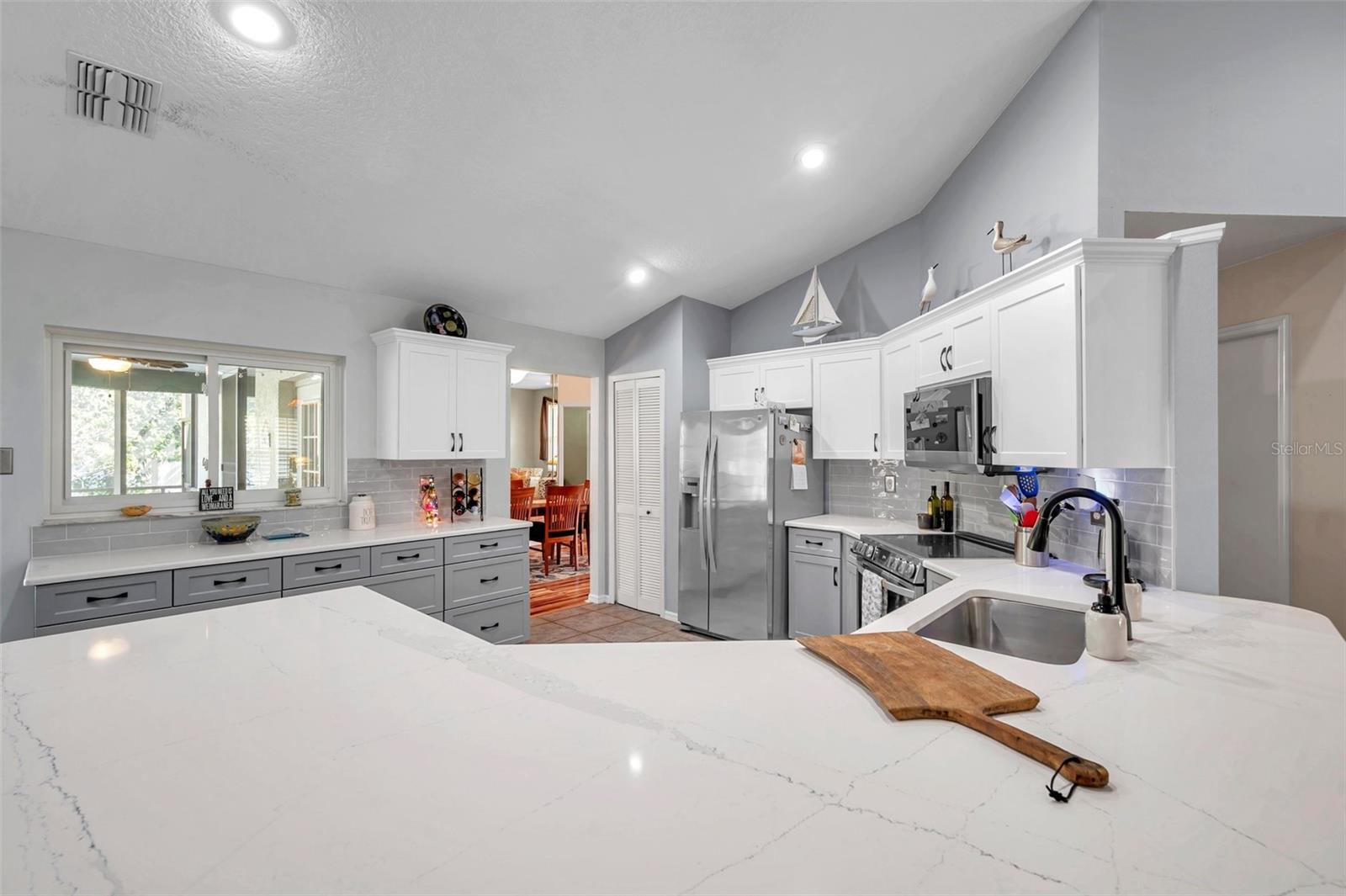 The counters are a beautiful quartz and the shaker cabinets come in grey and white