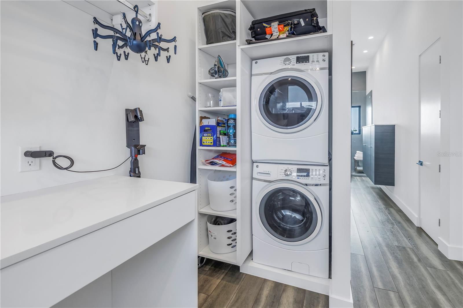 Laundry and folding table are conveniently located in primary closet.