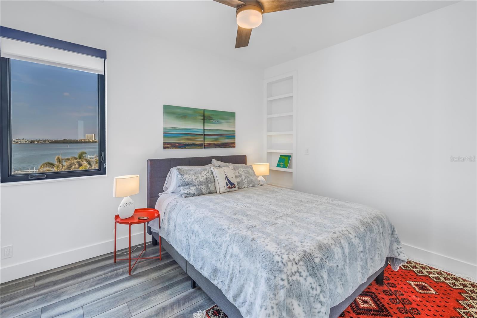 Guest bedroom with built in shelves.