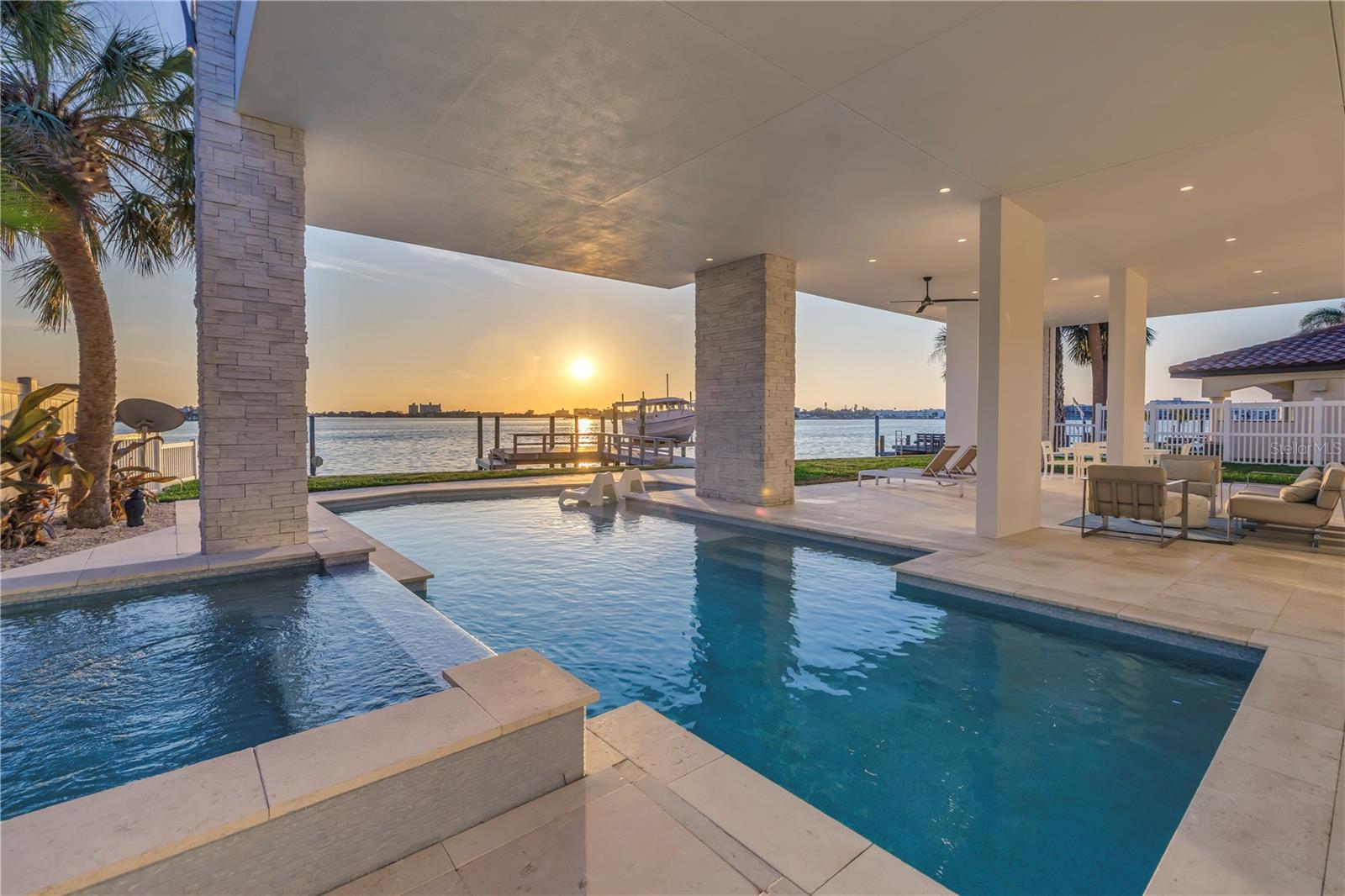 Travertine tile surrounding the pool.