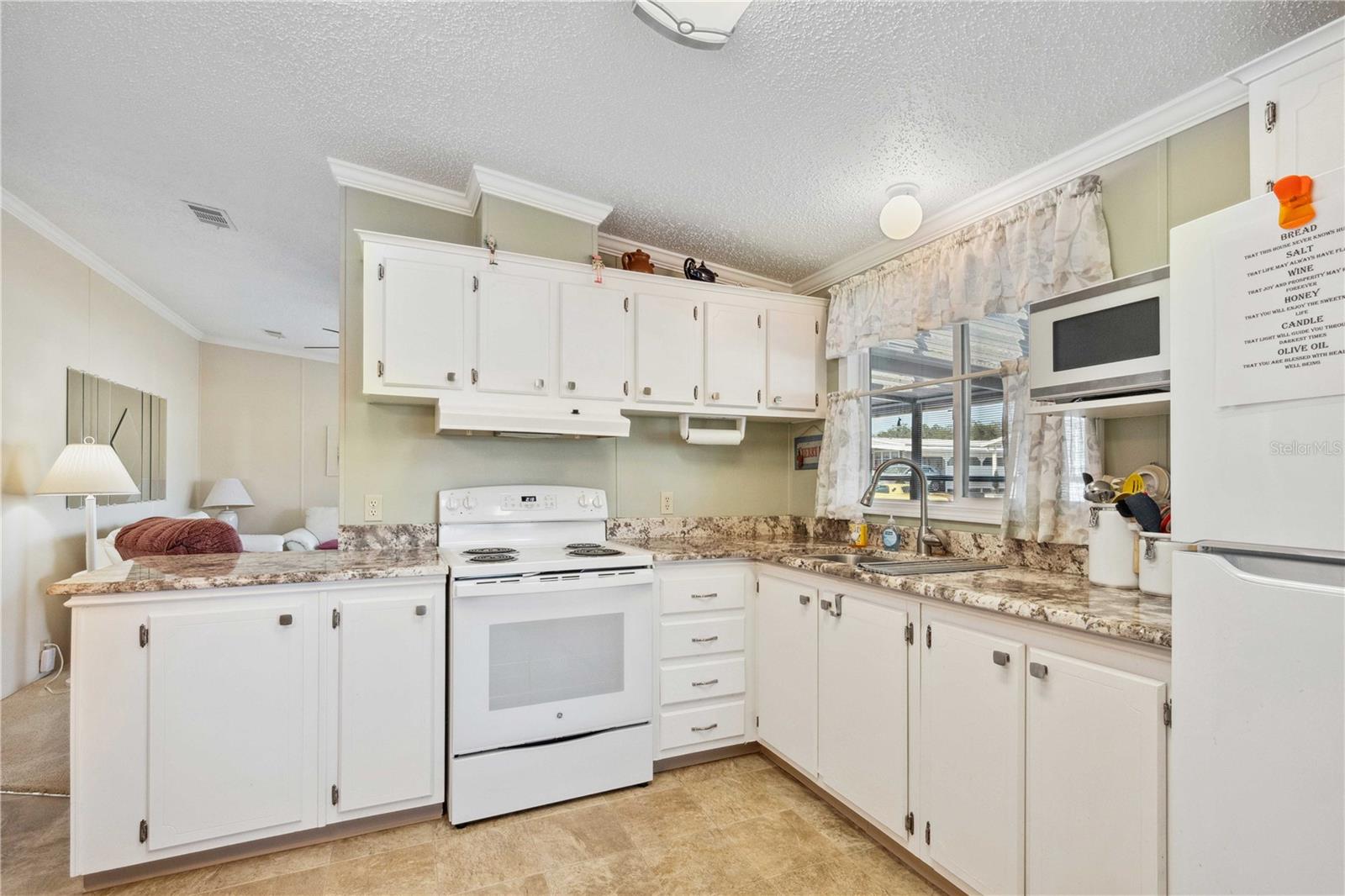 Granite counter tops in this updated kitchen.