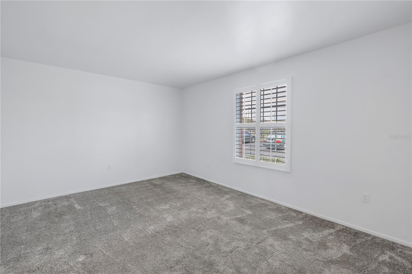 Primary bedroom with new carpeting.