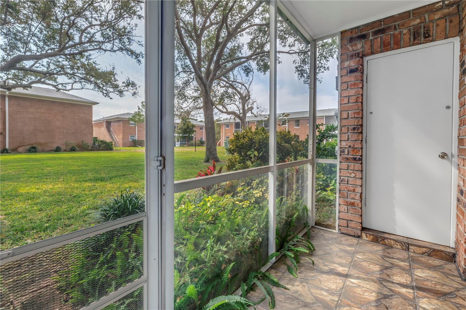 back screened in patio offers a storage closet.