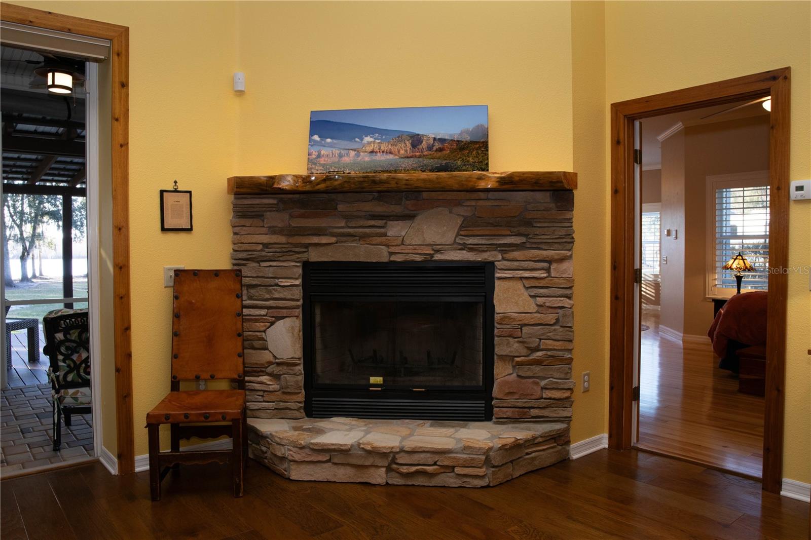 Rock wood burning fireplace with live edge mantel