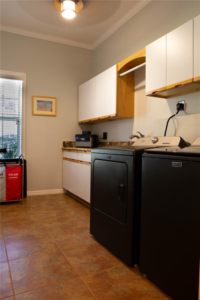 Laundry room with sink and folding counter and lots of storage