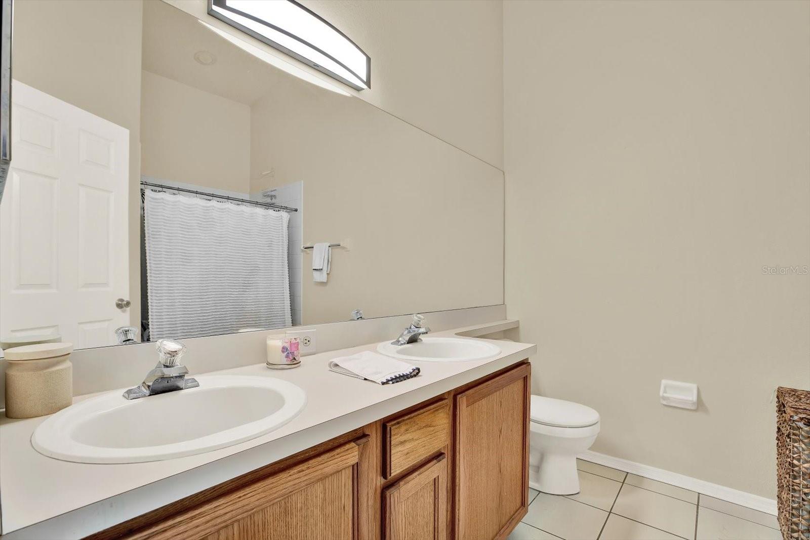 full bathroom with door to primary & door to hallway