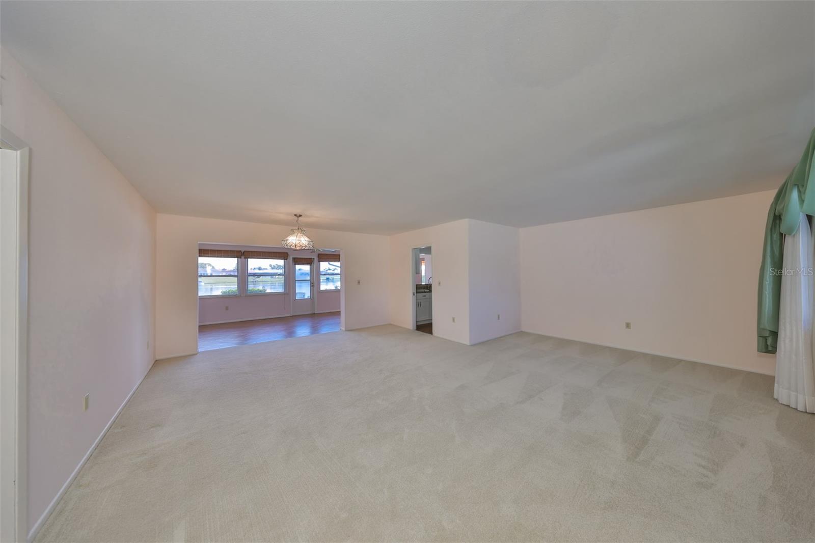 Living/dining room with view of lake as you walk in the front door.