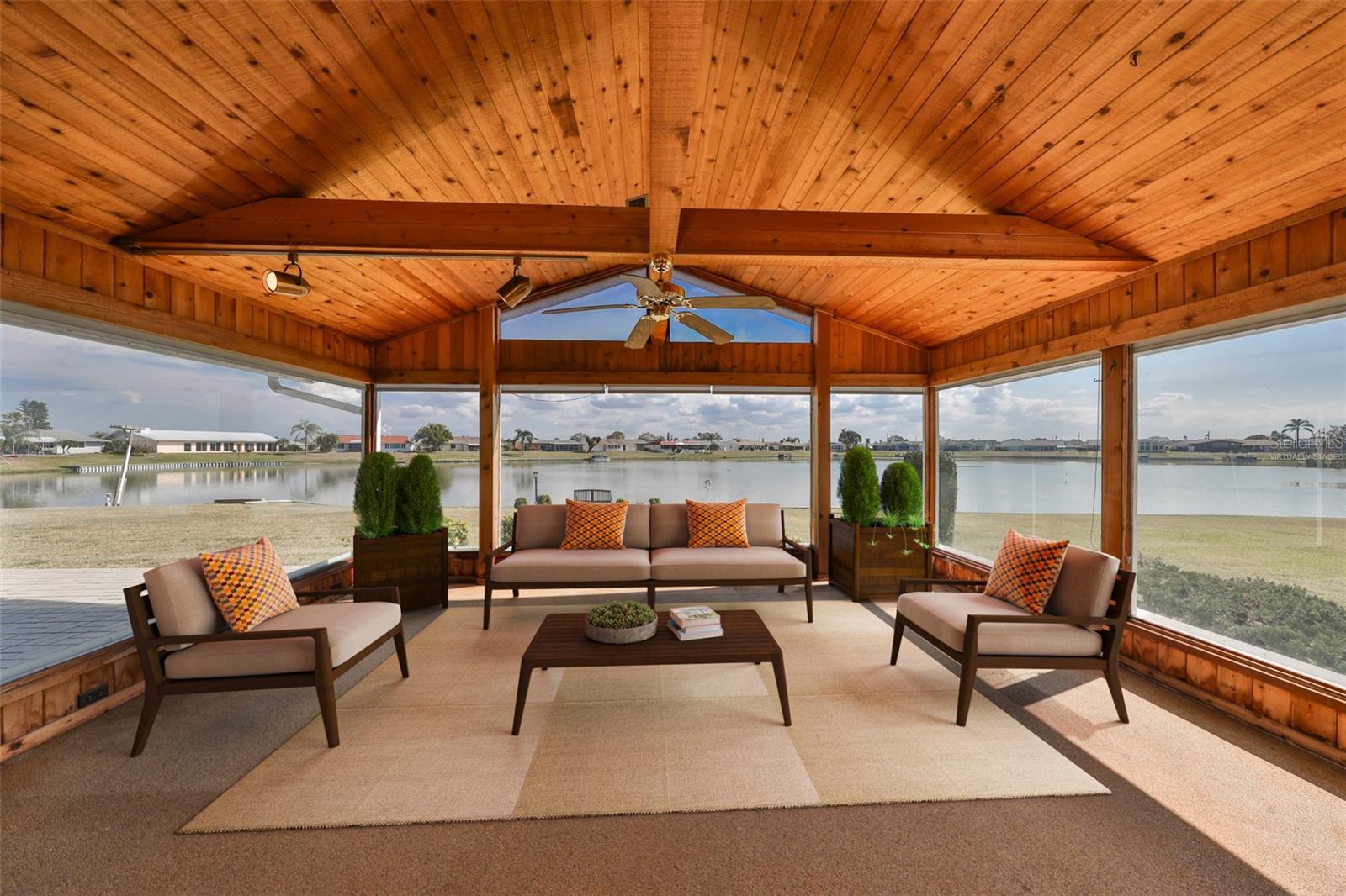 Virtually staged Sunroom.  Windows all around, with shades and storm shutters when needed.