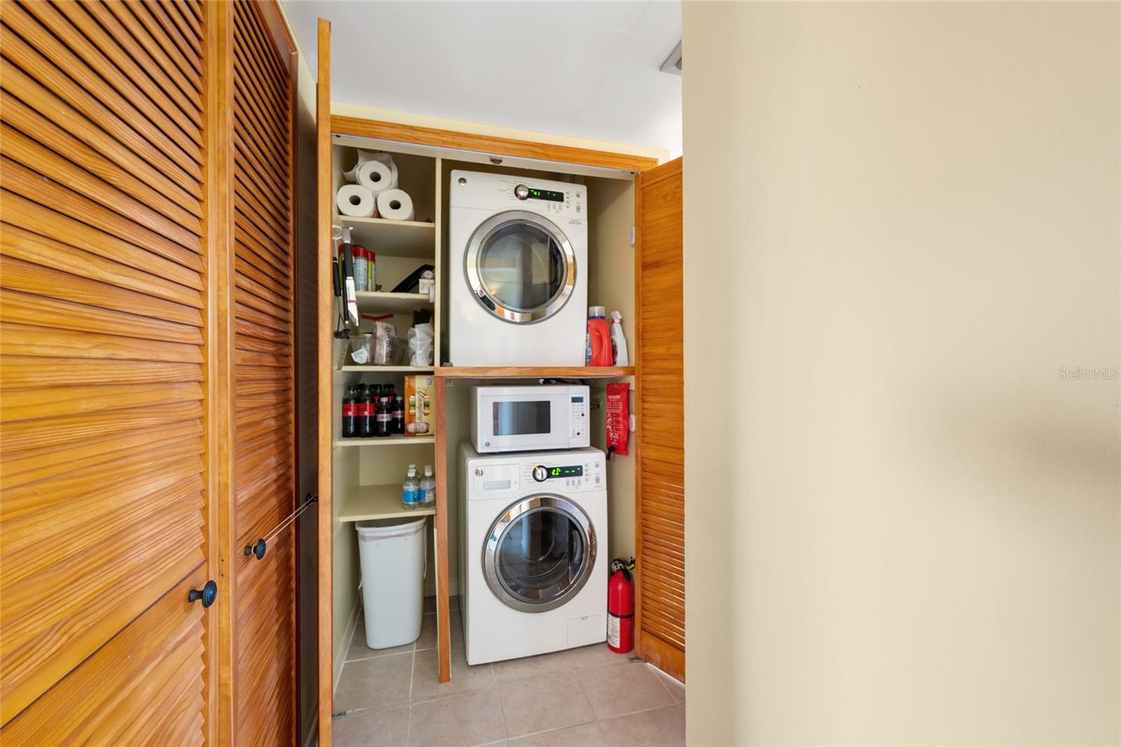 Washer and dryer conveniently located outside of the kitchen.