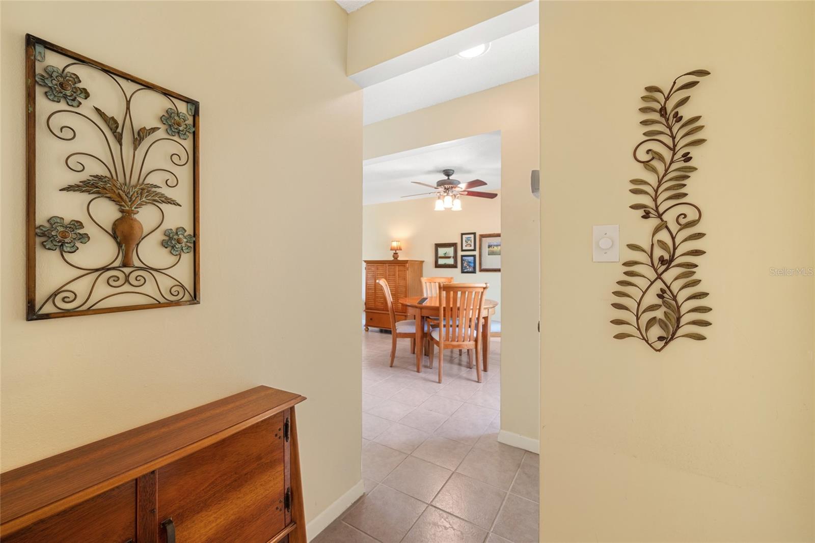 View towards front door and dining area from hallway that leads to bedrooms