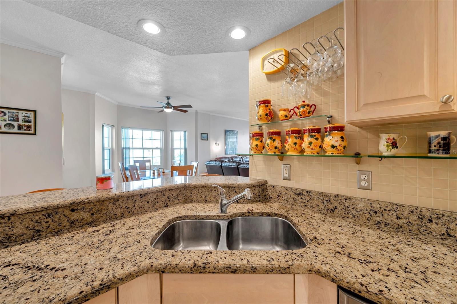 The kitchen features a breakfast bar open to the living spaces