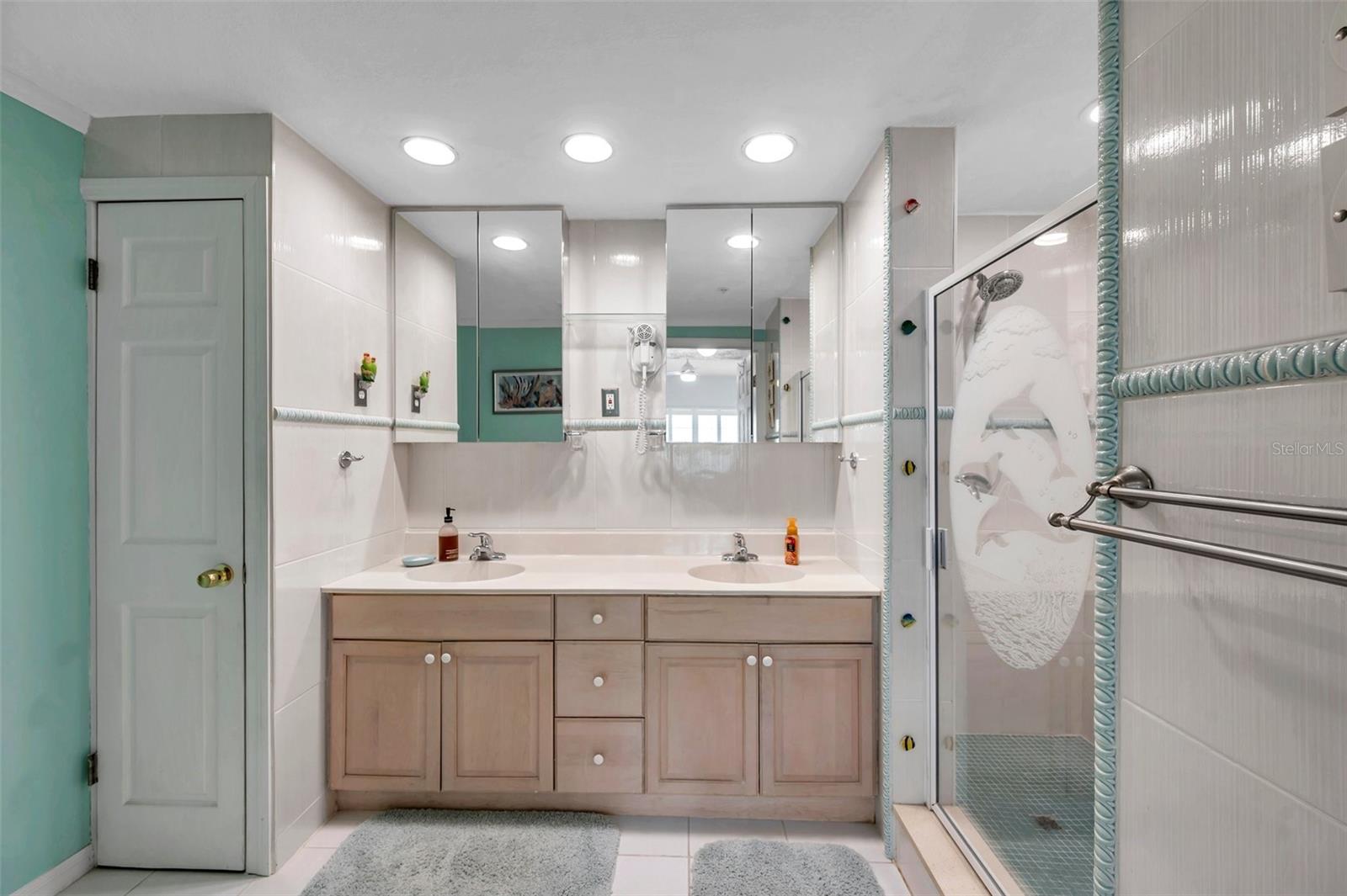 The spacious primary suite bathroom features a double vanity and a