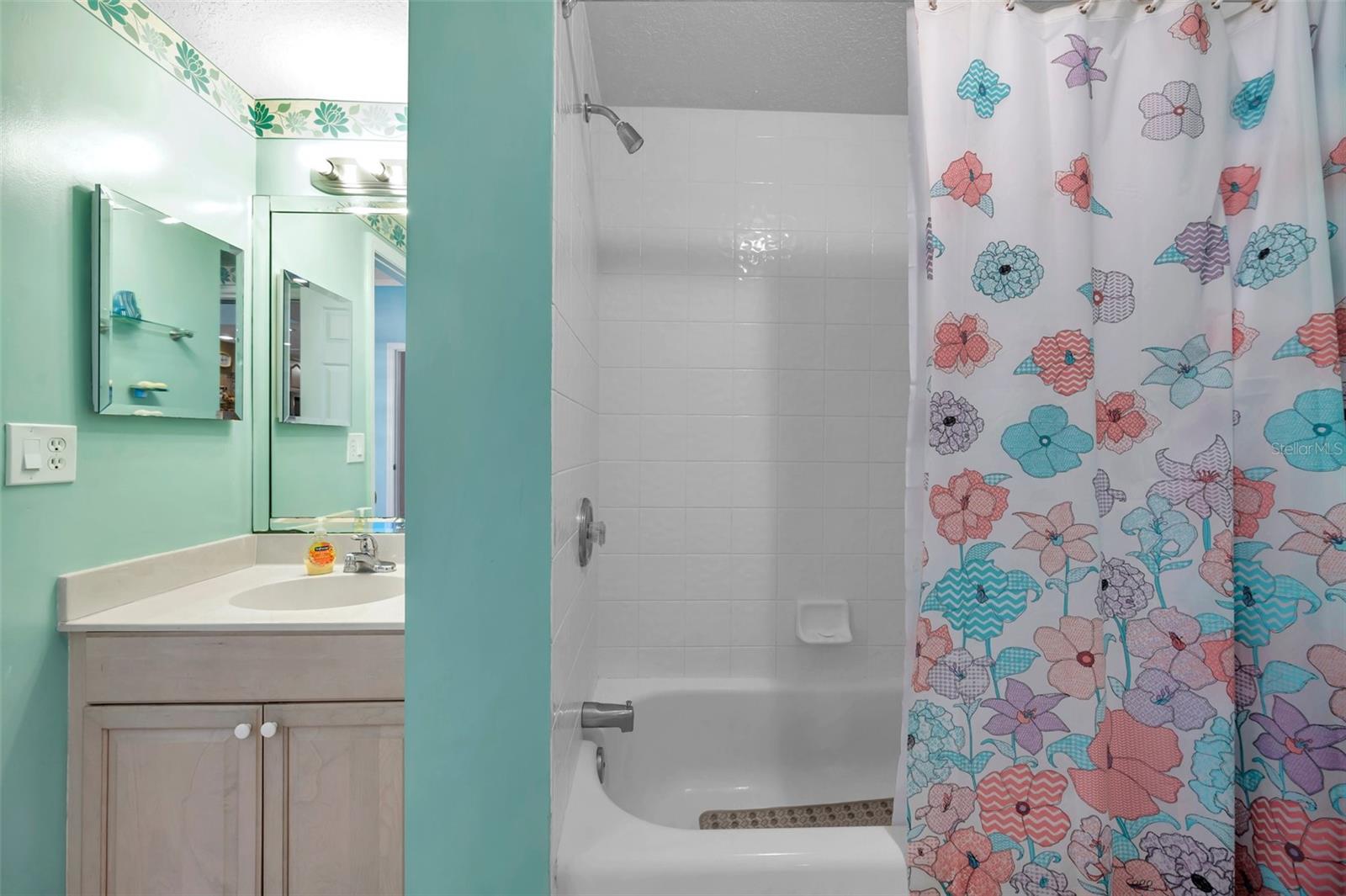 The guest bath features a tub shower combo