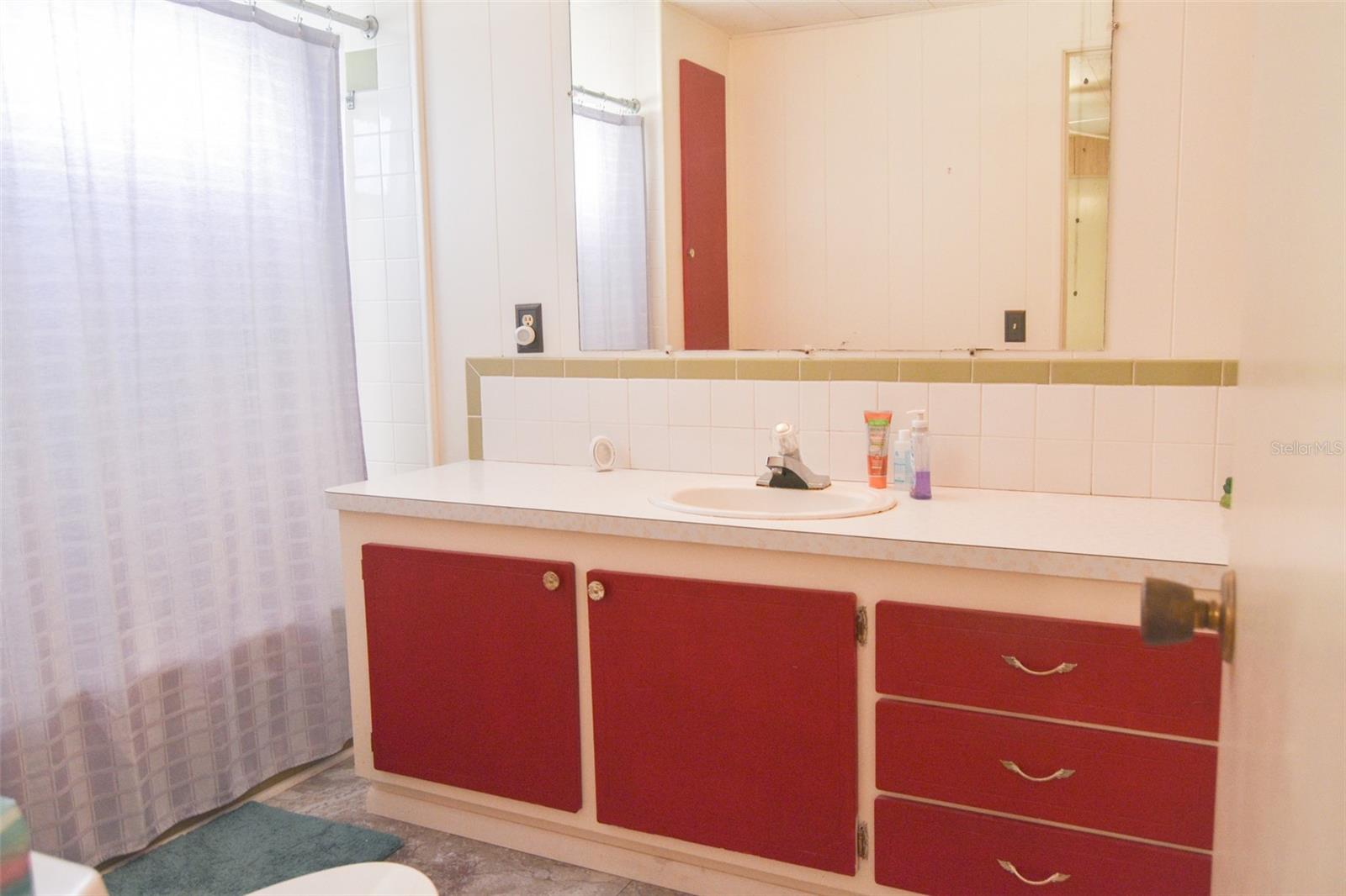 guest bathroom with tub and shower