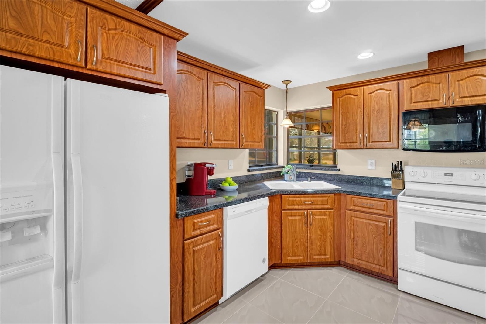 Solid wood cabinets, complementary counters with recessed & pendant lighting~