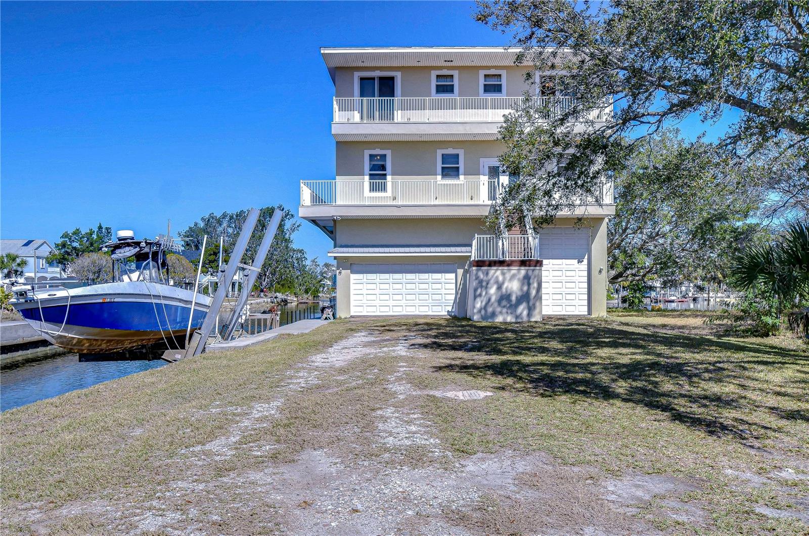 COMPLETE WITH A 13,000 POUND BOAT LIFT AND A FISH CLEANING STATION.