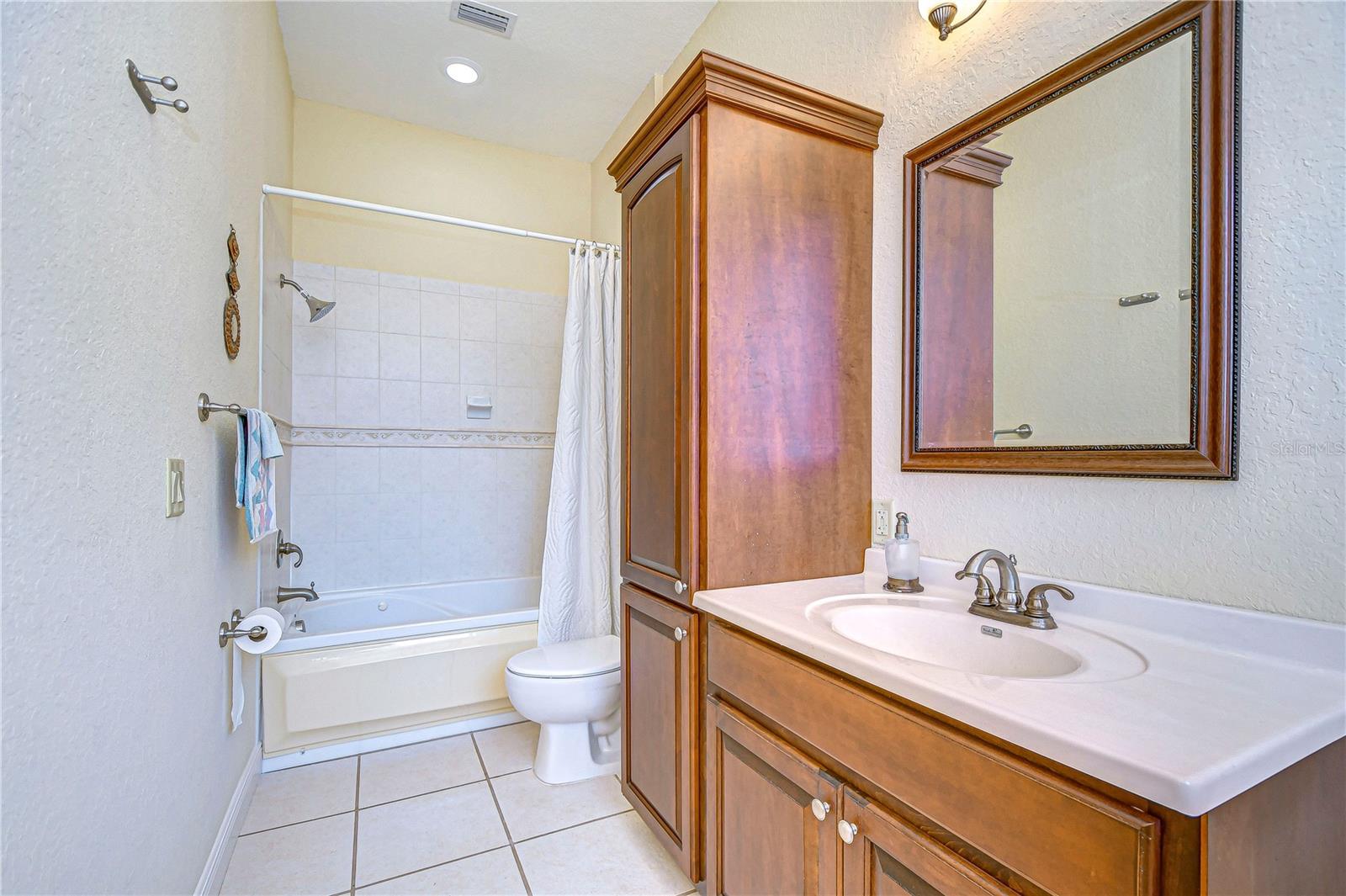 THE MAIN LEVEL BATHROOM IS JUST OFF THE GUEST BEDROOM.