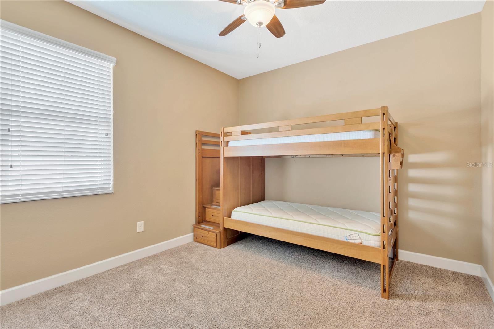 Bedroom #2 is 11.3' x 10.8' and has carpet, a ceiling fan and a built-in closet with custom shelves.  The bunk beds are available for the new owner.