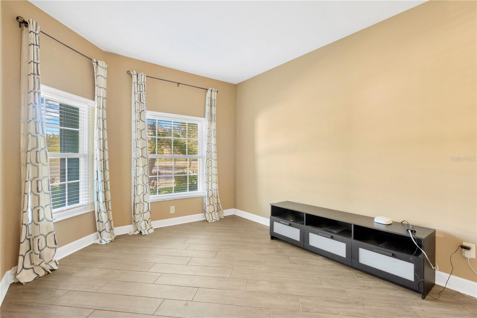 The spacious room located just inside the front entryway can be a 4th bedroom or office/den.  The low credenza will convey to the new owner.  There is no closet in this room.