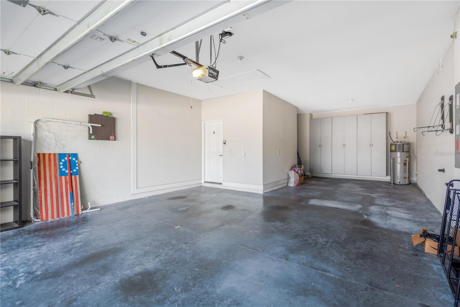 The 3-car garage measures 19.7' x 36' and comfortably fits three vehicles, with two parked in tandem.