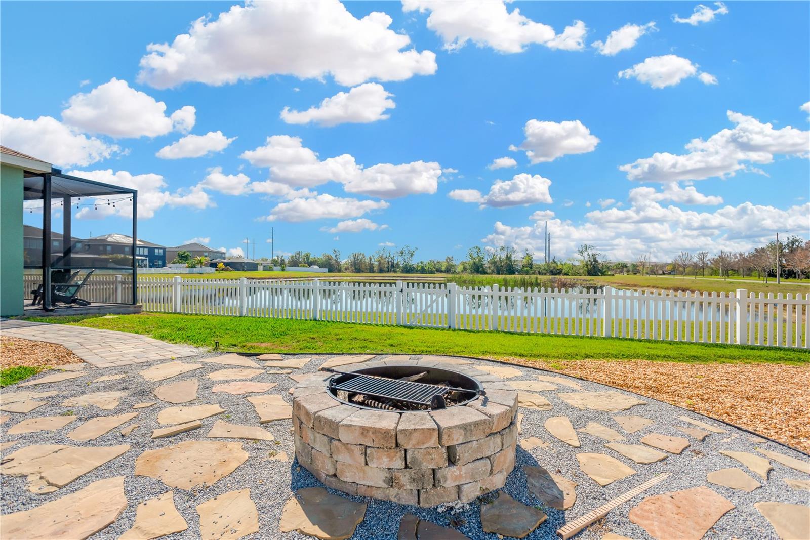 The pie-shaped backyard offers ample space for outdoor activities, complete with a fire pit and surrounding hardscaping.