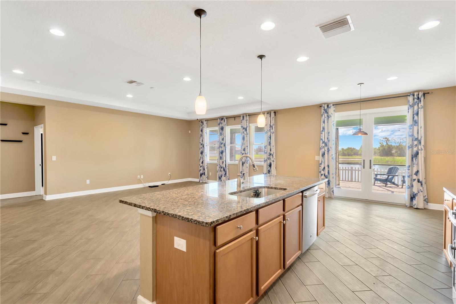 The large island has a single basin sink under-mounted and lots of counter space for prepping your meals or entertaining with additional bar seating.