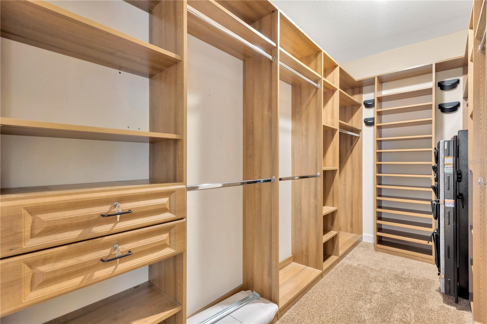 This jaw-dropping 13’ x 6’ walk-in closet has a custom storage system added by Closets by Design.  There is also a 5’x2’ gun safe concealed in the primary walk-in closet that will convey to the new owners.