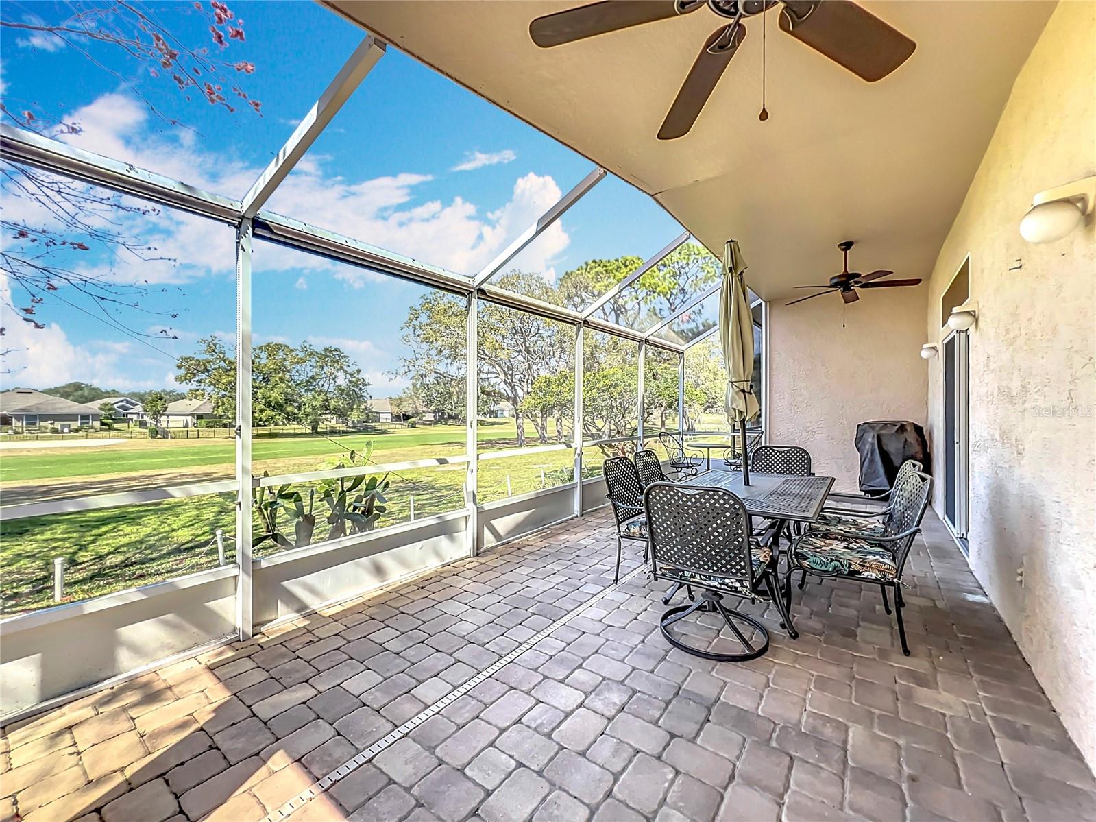 The patio has been completely paved with stone. Two ceiling fans will help circulate that air on those hot days.