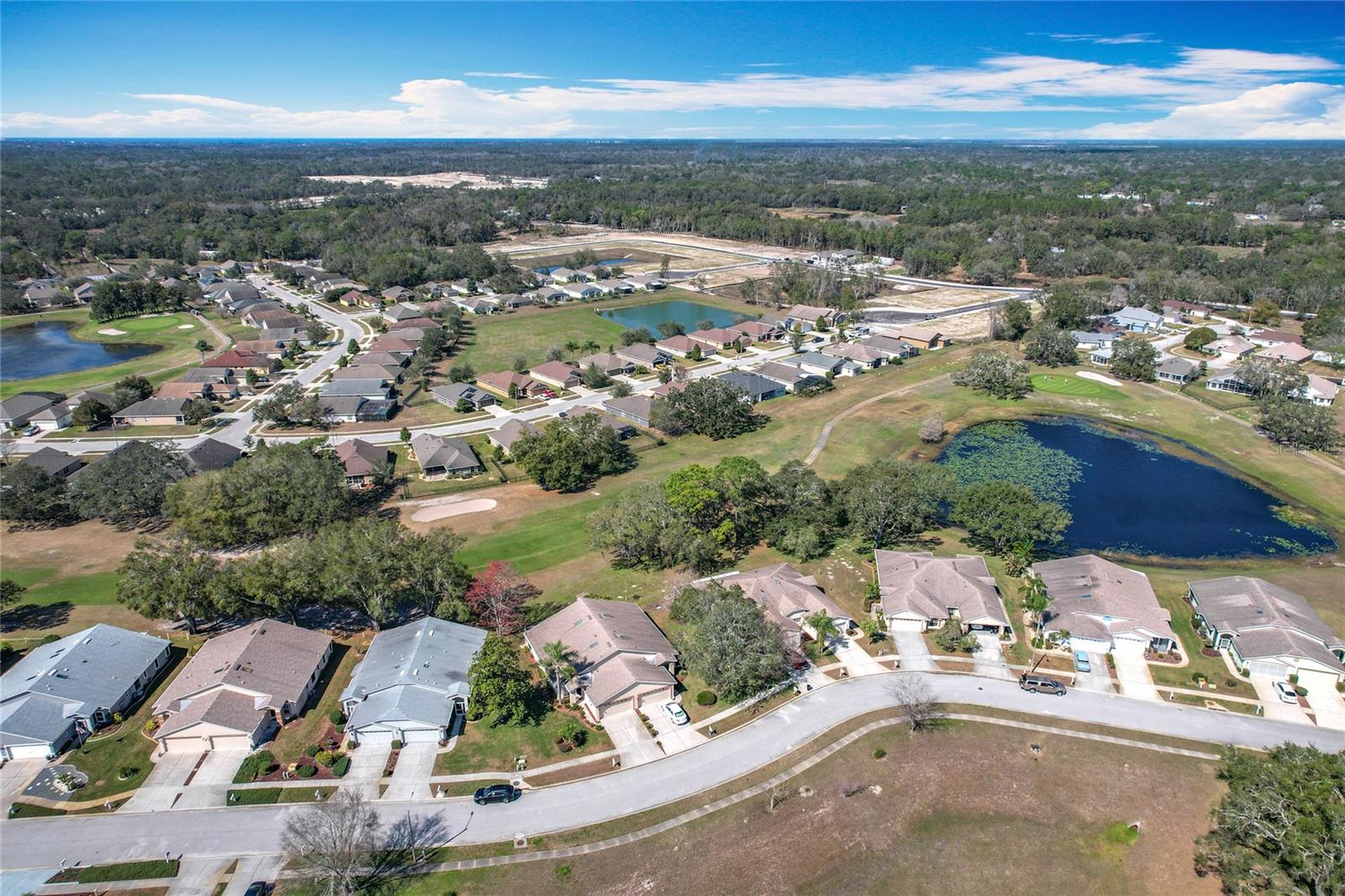 Overhead view of Norman Circle in the foreground with the golf course and the Reserve at Meadow Oaks community in the background.