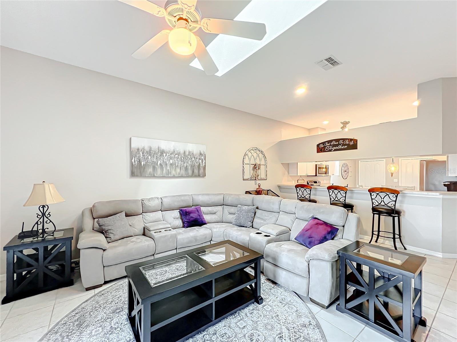 By utilizing the kitchen as a dining area as well allows for a great family room Space. The skylight also give off a lot of natural light.