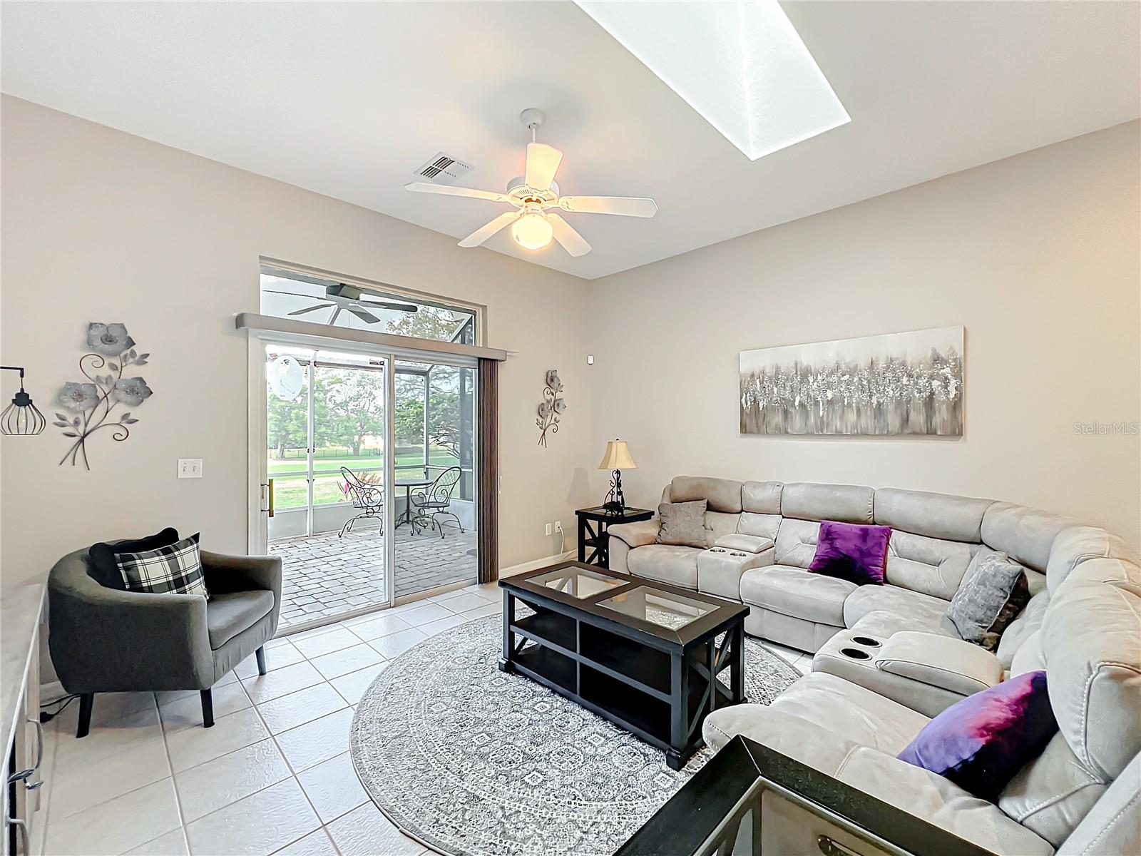 The family room opens out to the oversized patio area through double sliding doors. The 14th fairway is also in the background.