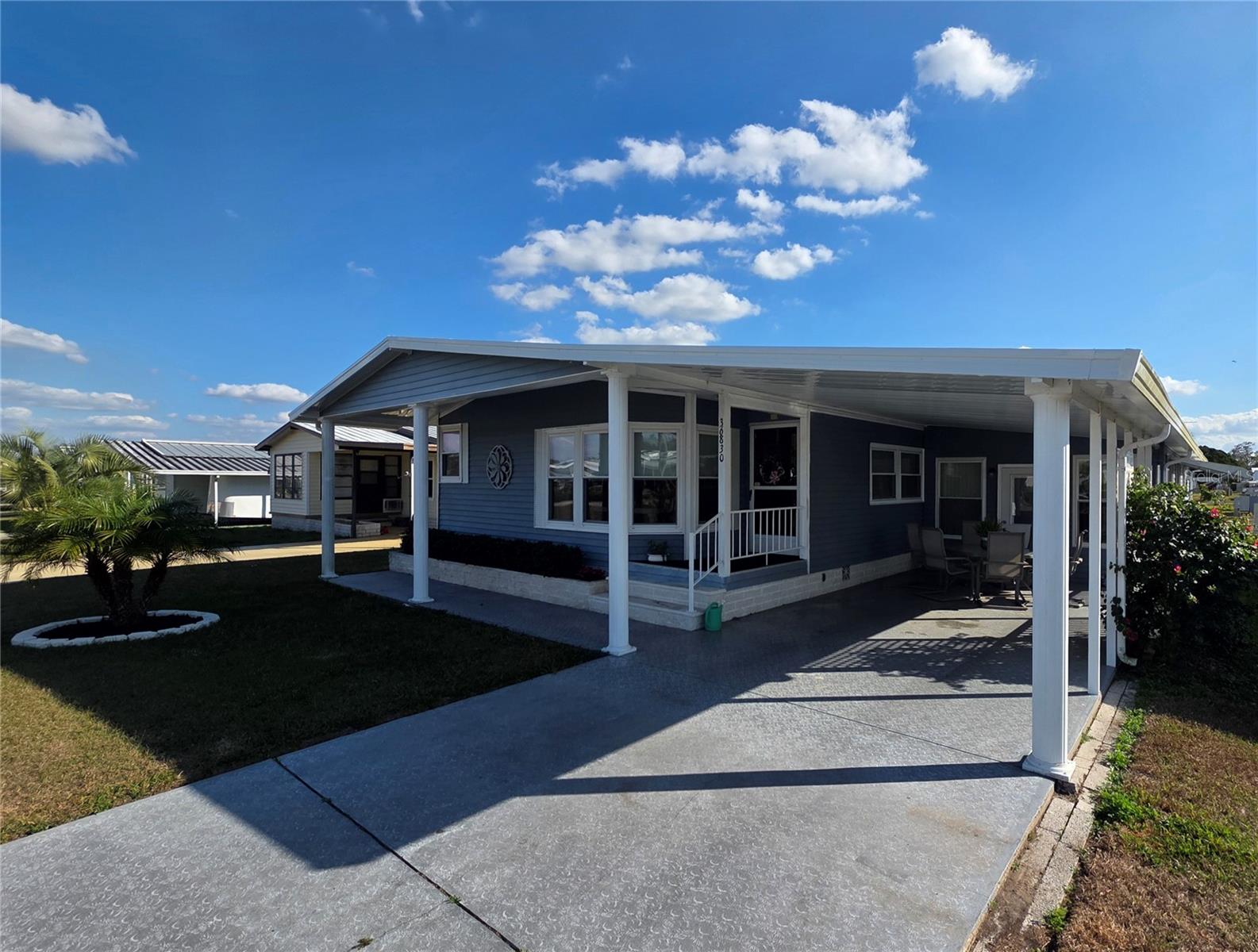 Painted driveway. Carport & covered front sidewalk.