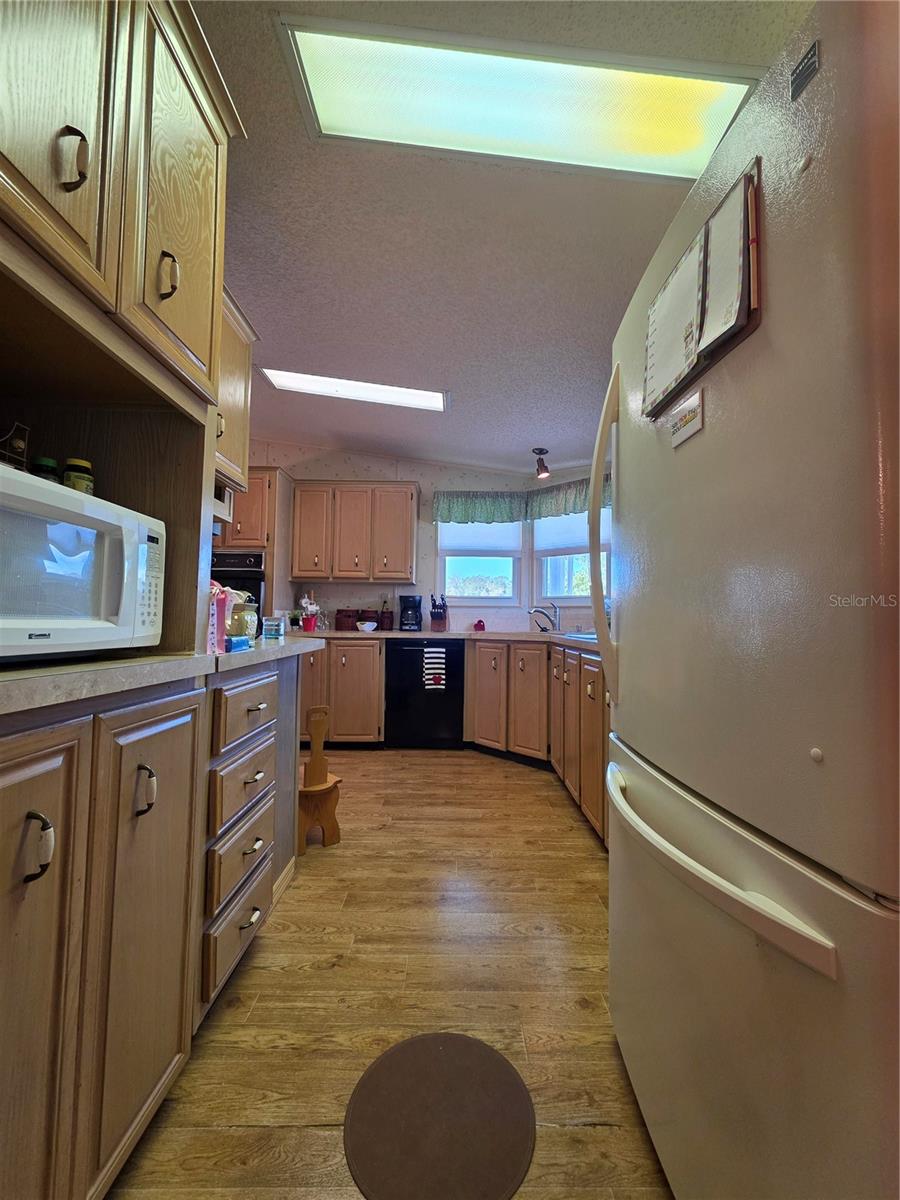 Large front kitchen with lots of cabinetry.