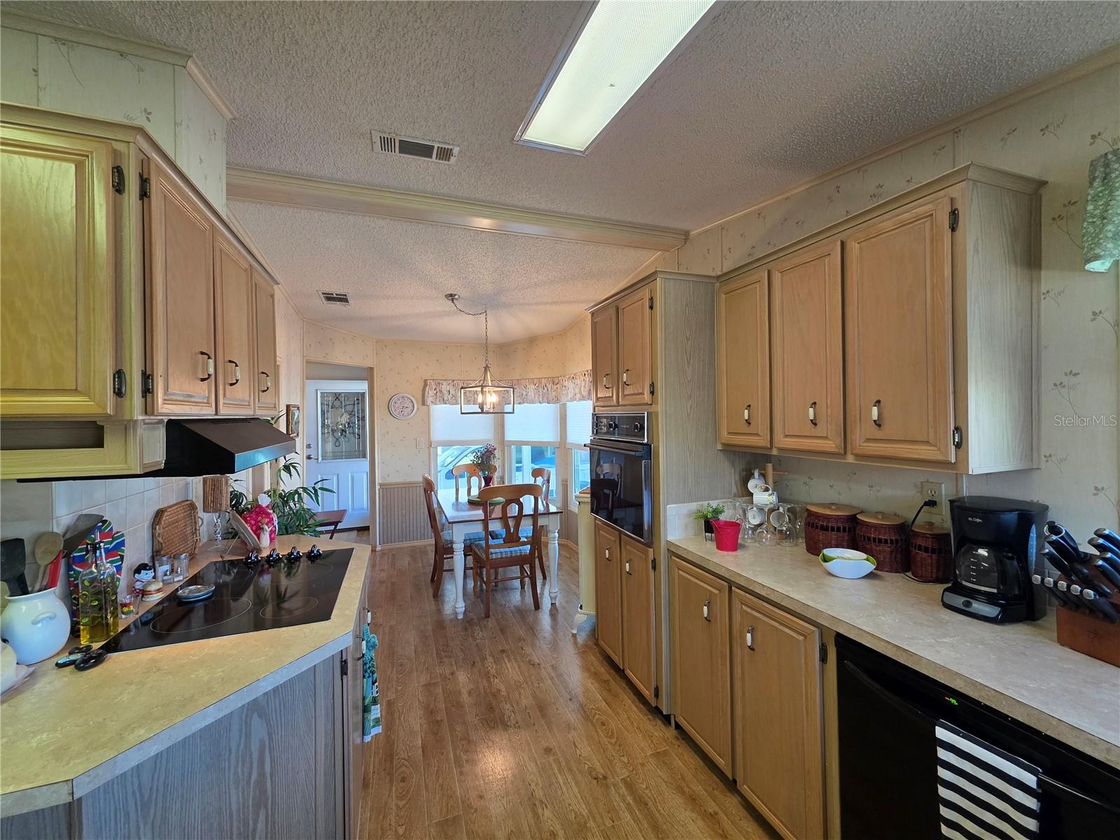 Large front kitchen with lots of cabinetry.