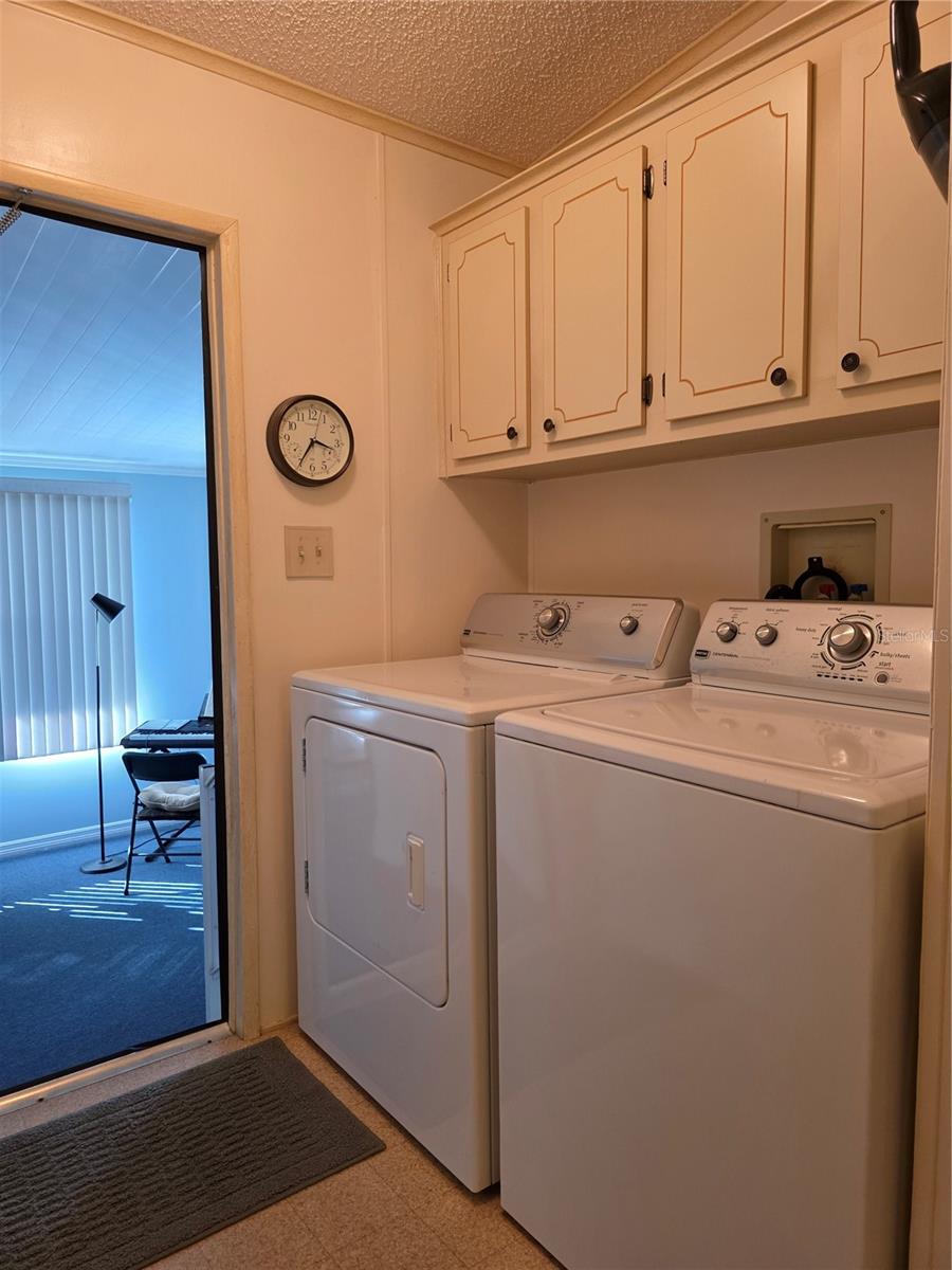 Laundry area with storage closet and cabinetry. washer/dryer are included.