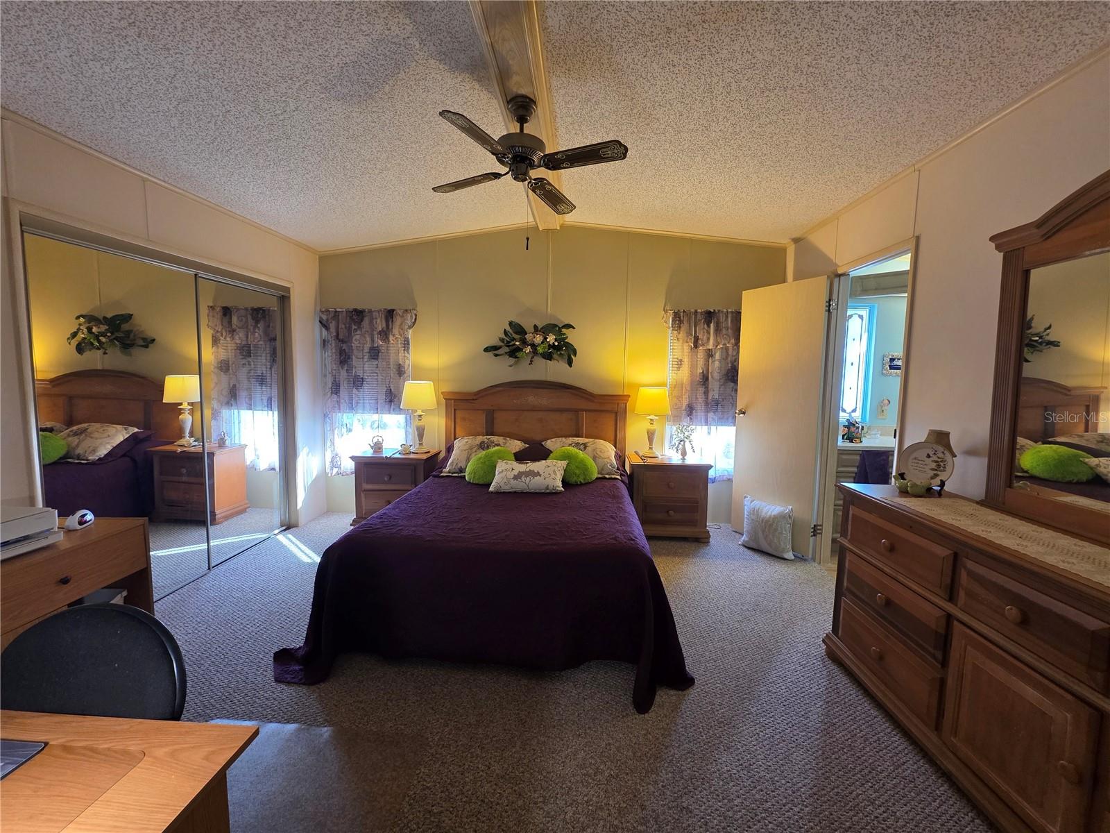 Primary bedroom with walk-in closet & en-suite bathroom.