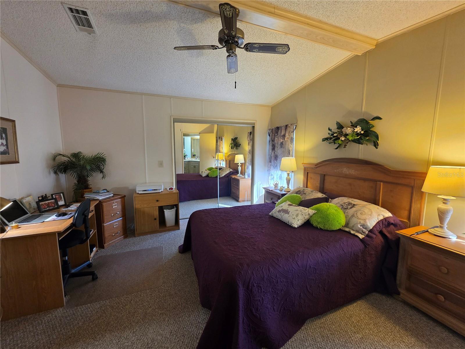 Primary bedroom with walk-in closet & en-suite bathroom.