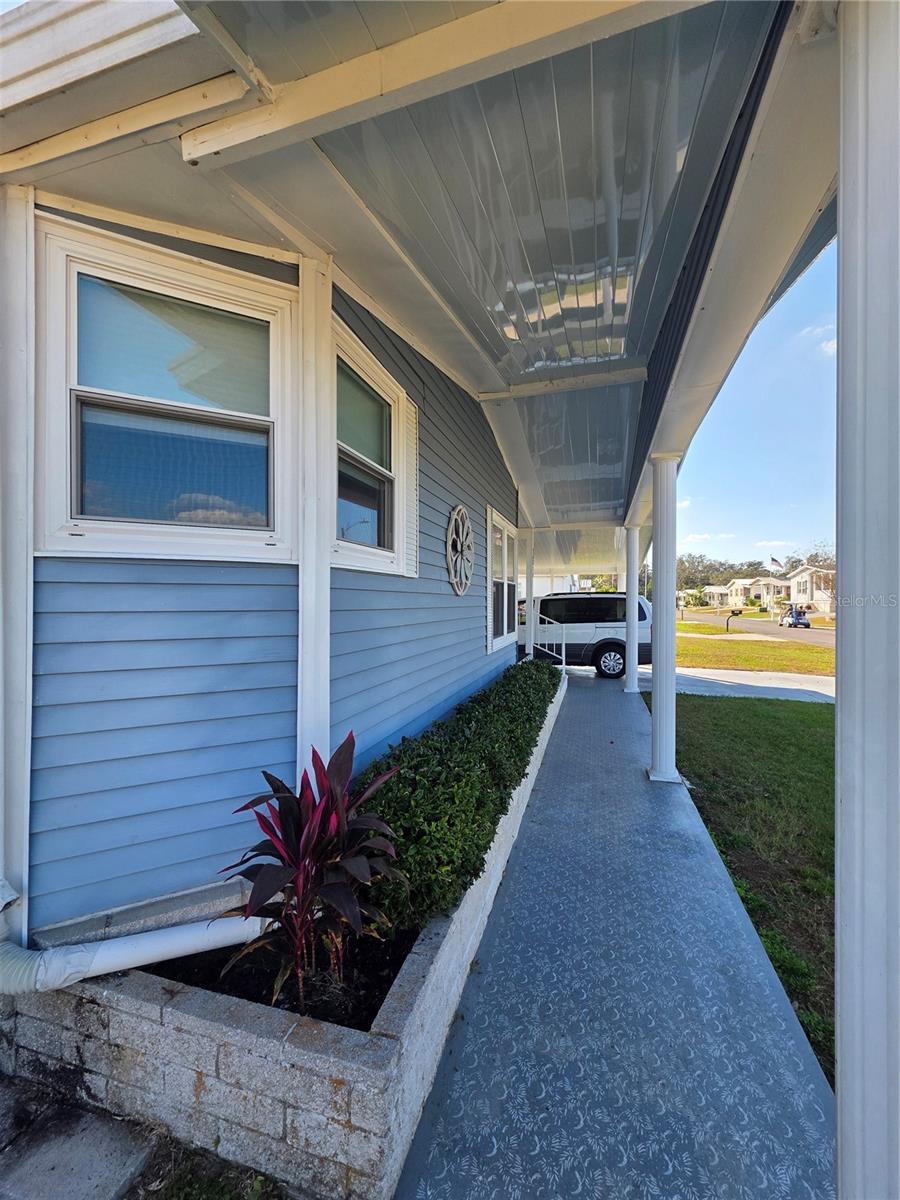 Covered front sidewalk & decorative brick front planer.