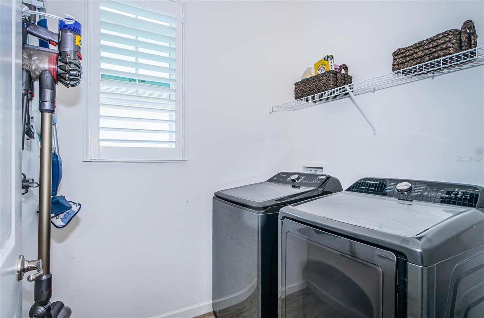 Laundry room is right off of the garage inside the home.