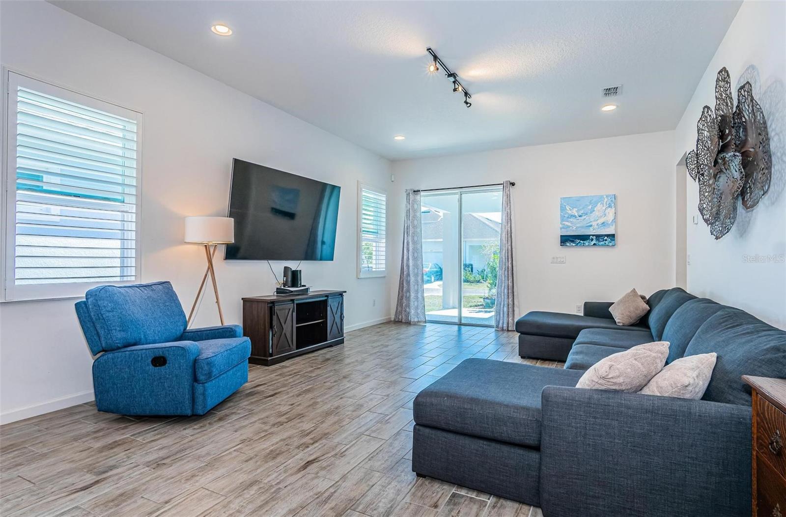 Large living room has a lanai just outside of the the sliding glass doors.