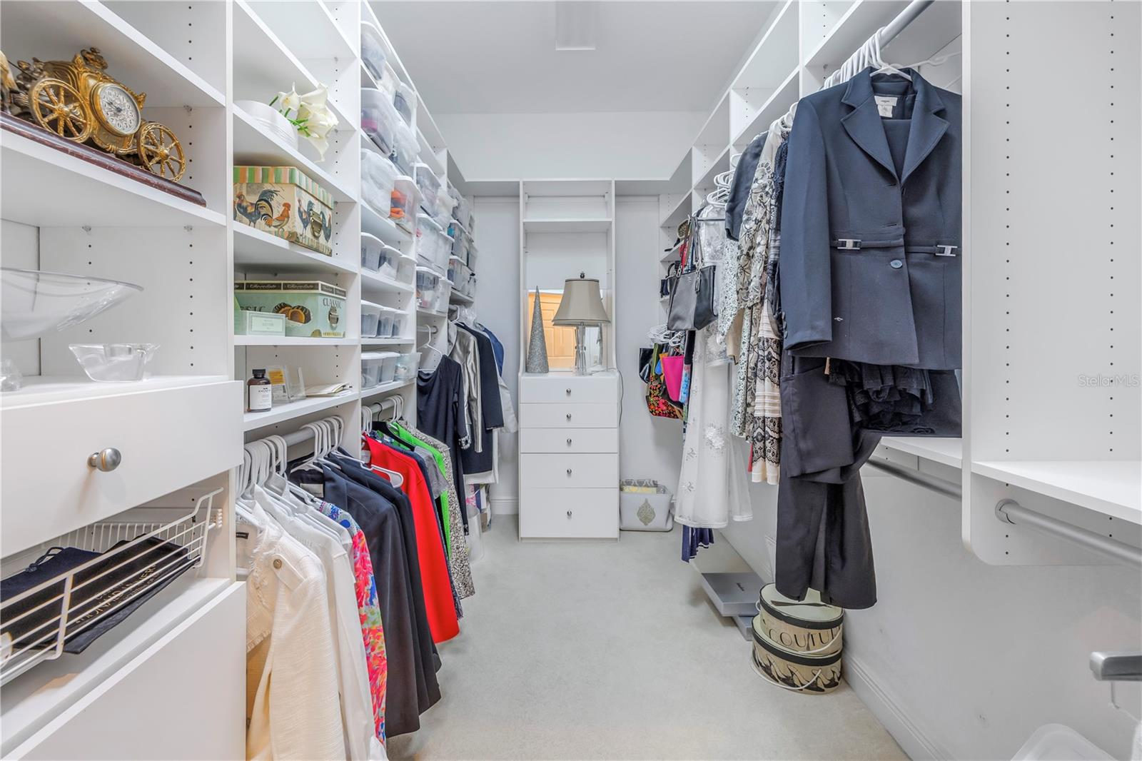 One of two large walk-in closets with custom closet organizers