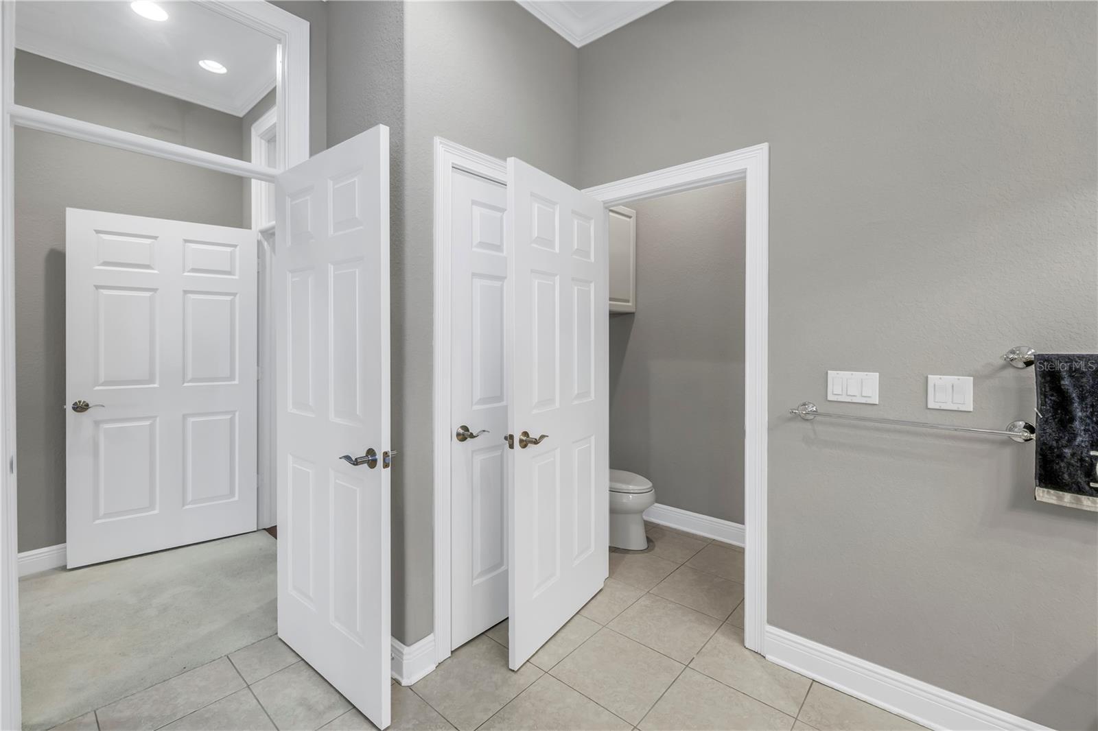 Private water closet & linen closet in primary bath