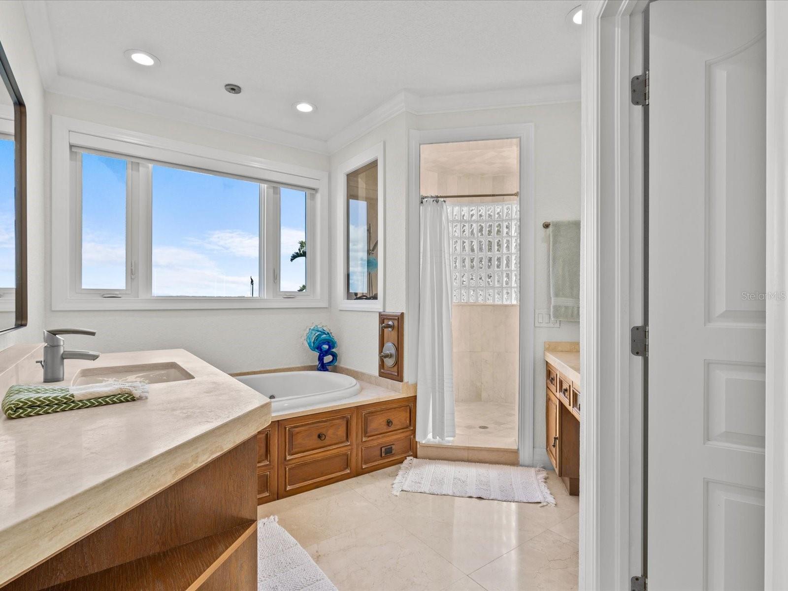 Primary bedroom en suite bathroom with jetted tub