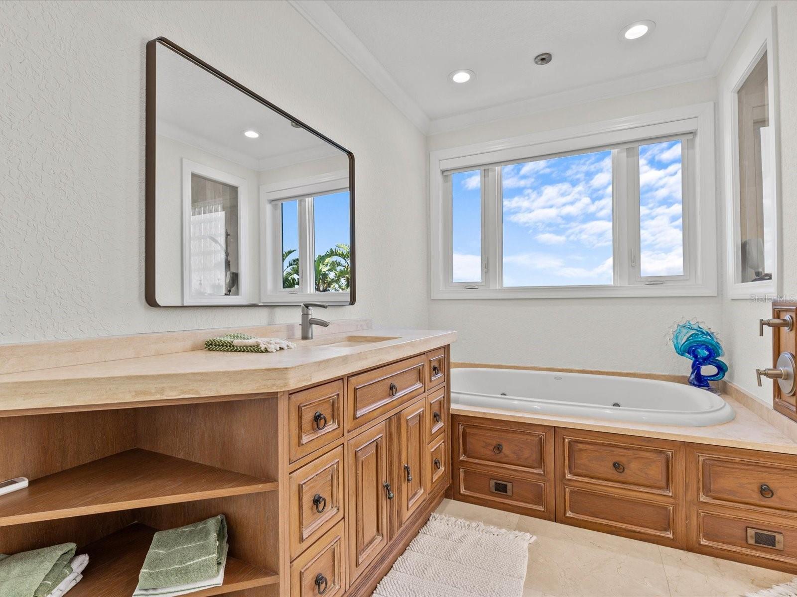 Primary bedroom en suite bathroom with jetted tub