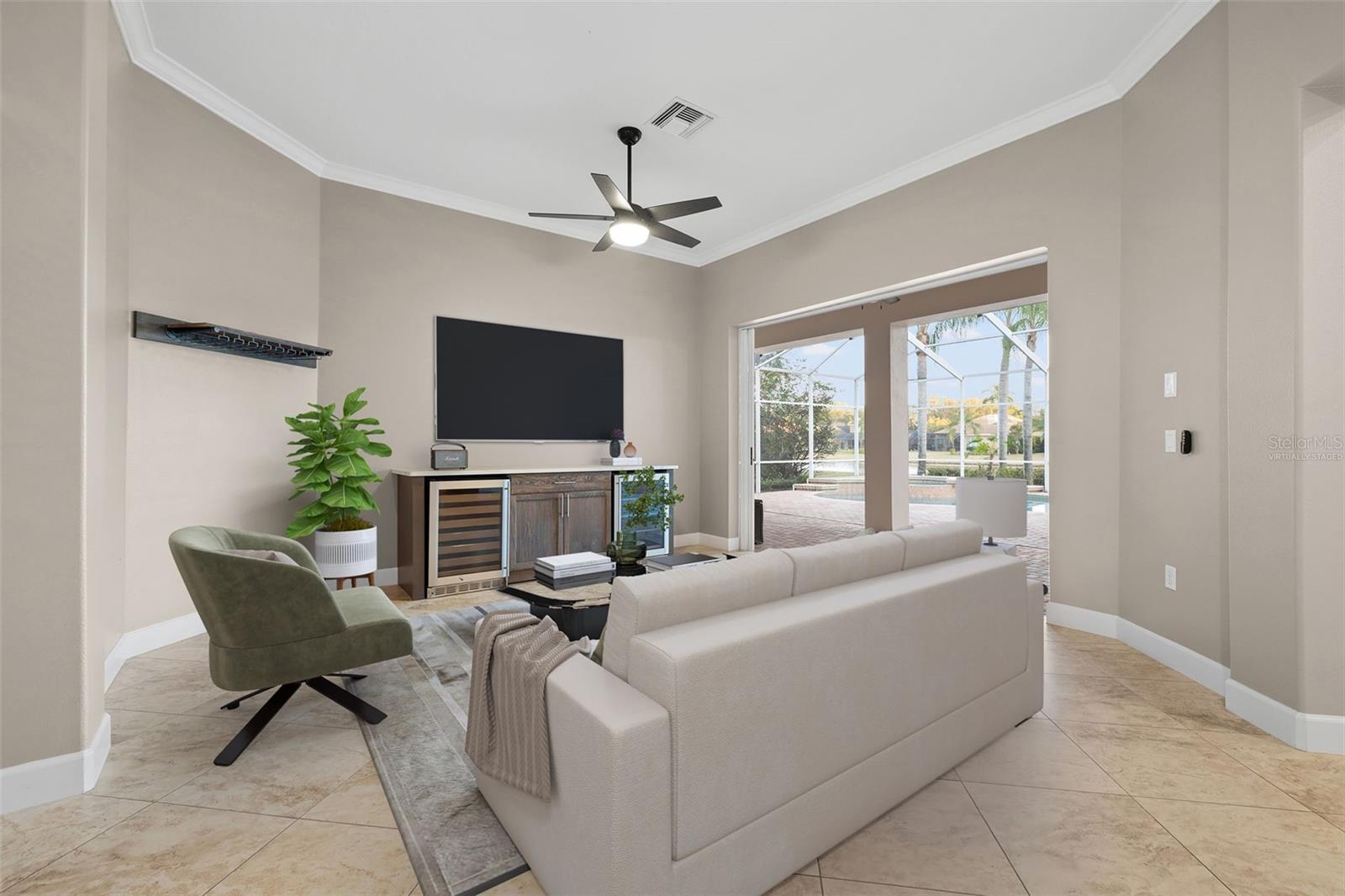 Virtually Staged - Living room with Wine Bar overlooking the pool/spa and pond